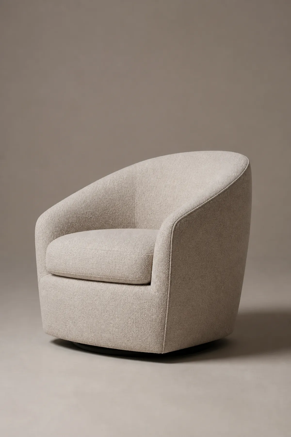 Profile view of a barrel chair showing its rounded back and curved arms